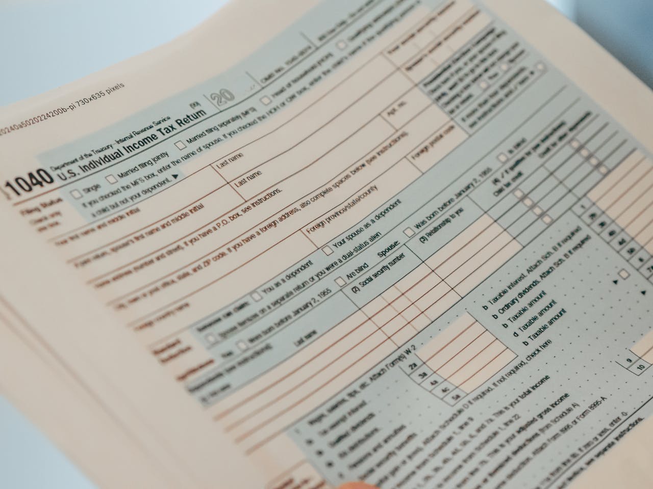 about-bg Detailed close-up image of a U.S. 1040 Individual Income Tax Return form, ideal for finance-related content.